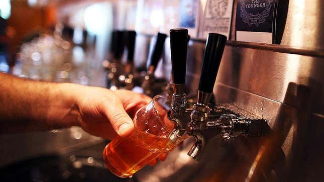 Pouring beer into glass from tap