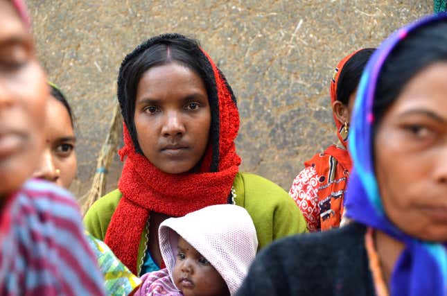 A young mother in the village of Jamkani listens to community workers talk about maternal health and nutrition.
