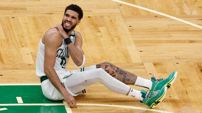 Boston’s Jayson Tatum lies on the court after a possible injury in the fourth quarter against the Miami Heat in Game Three of the 2022 NBA Playoffs Eastern Conference Finals.