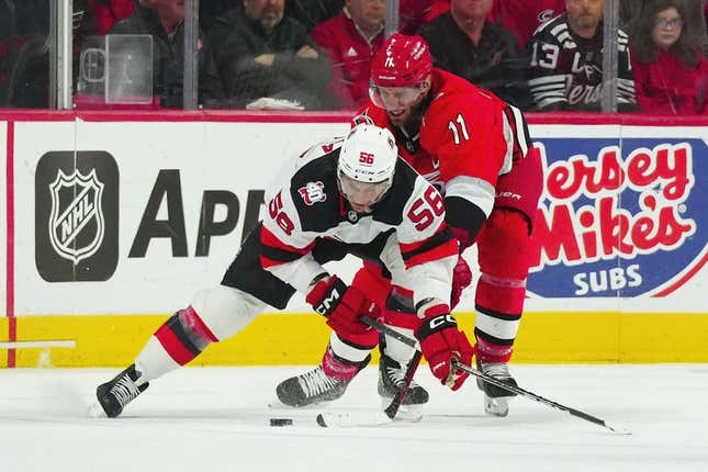 May 3, 2023; Raleigh, North Carolina, USA; New Jersey Devils left wing Erik Haula (56) skates with the puck against Carolina Hurricanes center Jordan Staal (11) during the first period in game one of the second round of the 2023 Stanley Cup Playoffs at PNC Arena.