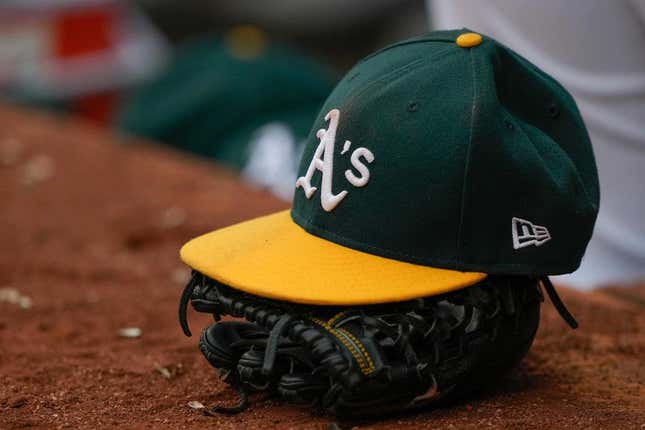 Jun 30, 2021; Oakland, California, USA;  General view of the Oakland Athletics hat and glove during the third inning against the Texas Rangers at RingCentral Coliseum.