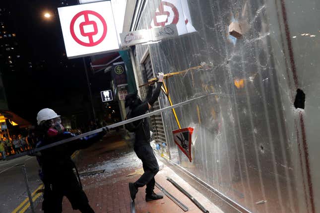 Protesters vandalize a Bank of China branch.