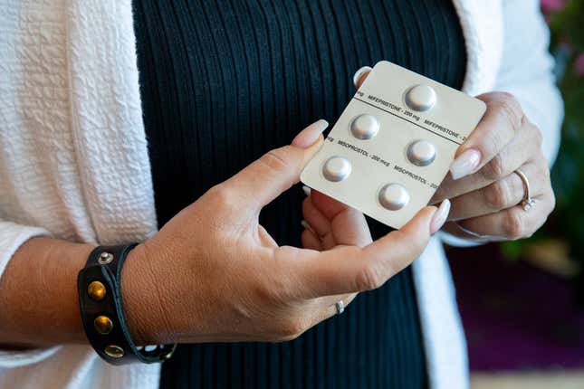 Melissa Grant, chief operating officer of Carafem, holds up mifepristone and misoprostol pills used for abortion at the headquarters of Carafem in Washington, D.C., on July 1, 2022.