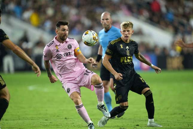 Sep 3, 2023; Los Angeles, California, USA; Inter Miami CF forward Lionel Messi (10) and LAFC midfielder Mateusz Bogusz (19) battle for the ball at BMO Stadium.