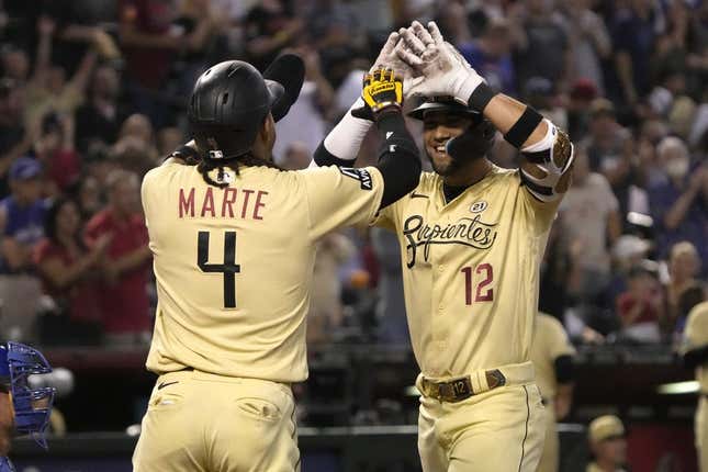 Sep 15, 2023; Phoenix, Arizona, USA; Arizona Diamondbacks left fielder Lourdes Gurriel Jr. (12) celebrates with second baseman Ketel Marte (4) after hitting a three run home run against the Chicago Cubs in the first inning at Chase Field.