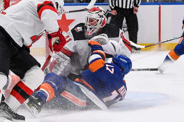 Mar 27, 2023; Elmont, New York, USA;  New York Islanders left wing Matt Martin (17) falls into New Jersey Devils goaltender Vitek Vanecek (41) during the second period at UBS Arena.