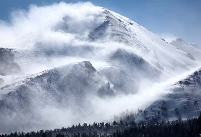 Snow blows off mountain ridges in the Sierra Nevadas. 