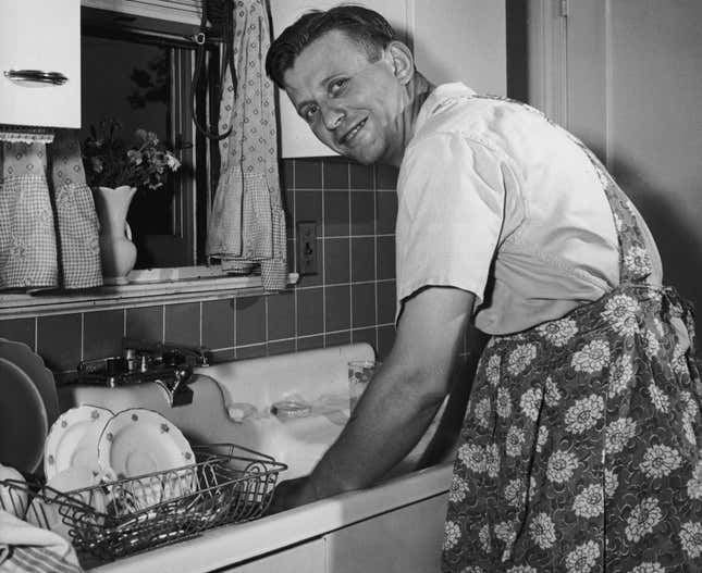 The rare sight of a man washing dishes in the 1950s.