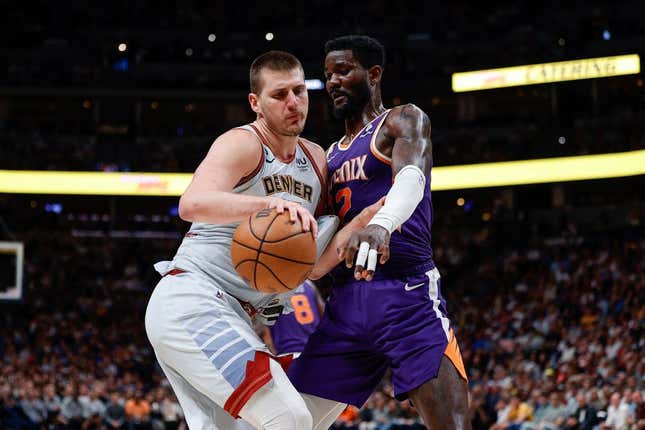 May 9, 2023; Denver, Colorado, USA; Denver Nuggets center Nikola Jokic (15) controls the ball as Phoenix Suns center Deandre Ayton (22) defends in the fourth quarter during game five of the 2023 NBA playoffs at Ball Arena.