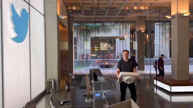 elon musk walking with a sink into the Twitter offices, surrounded by desks and the giant Twitter symbol