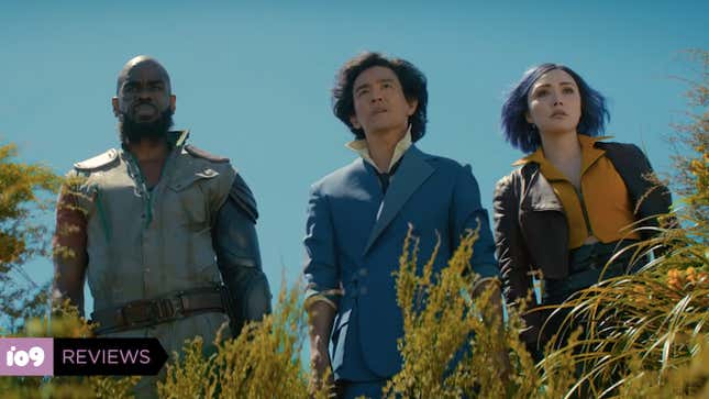  Mustafa Shakir's Jet Black, John Cho's Spike Spiegel, and Daniella Pineda's Faye Valentine stand in a row amidst bushes staring at something unseen.