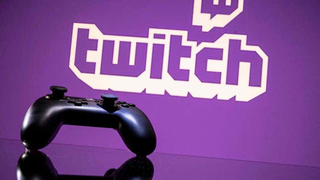 A video game controller sits in front of a Twitch logo. 