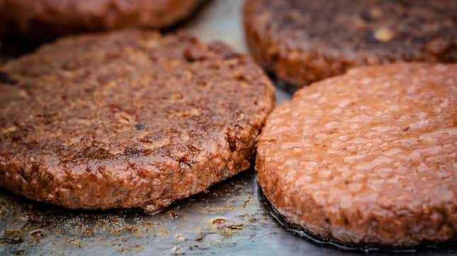 vegan burgers cooking on grill