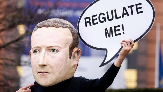 An activist wears a mask depicting Mark Zuckerberg outside the European Commission building in December.