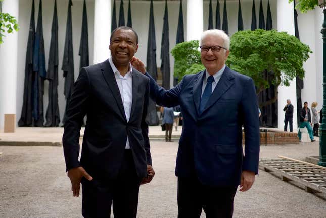 Okwui Enwezor, left, curator of the 56th edition of the Venice Biennale of Arts poses with Biennale President Paolo Baratta at the 56th Biennale of Arts in Venice.