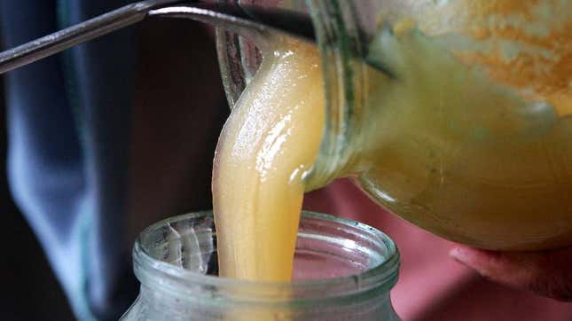 honey pouring into jar