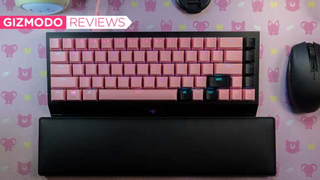 Image showing the black wireless razer keyboard with pink and black keycaps on a pink desk mat