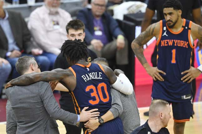 Apr 26, 2023; Cleveland, Ohio, USA; New York Knicks forward Julius Randle (30) is helped to his feet in the second quarter during game five of the 2023 NBA playoffs against the Cleveland Cavaliers at Rocket Mortgage FieldHouse.