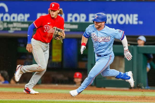 Apr 2, 2023; Arlington, Texas, USA; Texas Rangers right fielder Robbie Grossman (4) rounds first base during the seventh inning against the Philadelphia Phillies at Globe Life Field.