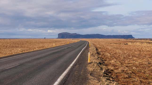A view of a mountain plateau in the distance from a highway in Iceland