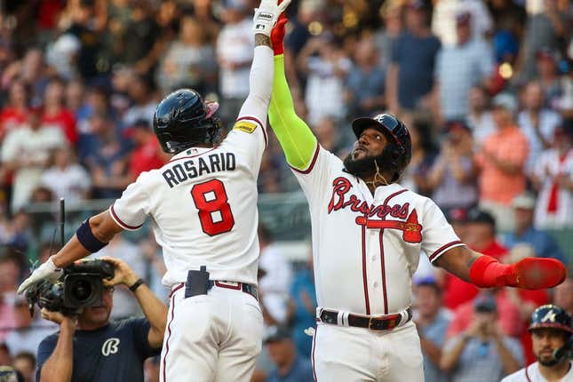 Aug 16, 2023; Atlanta, Georgia, USA; Atlanta Braves left fielder Eddie Rosario (8) celebrates after a home run with designated hitter Marcell Ozuna (20) against the New York Yankees in the second inning at Truist Park.