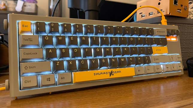 A photo of the Shurikey Hanzo Retro Computer model keyboard, with gray frame, dark gray alpha keys with white legends, and bright yellow accents. 