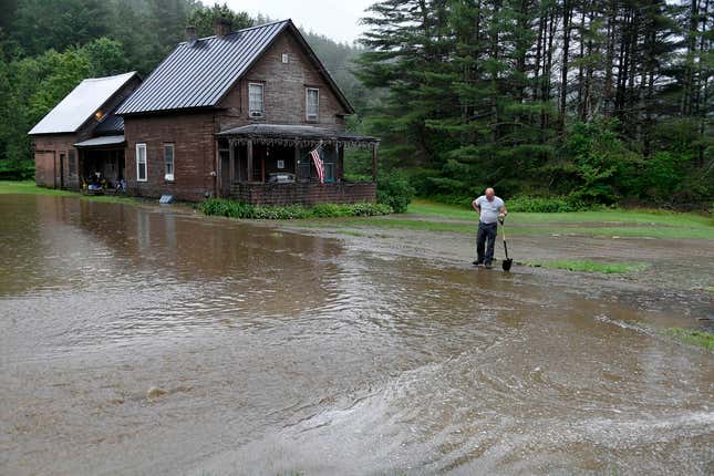 Shawn McManis checks rising water outside his cousin’s home in Worcester, Vt. on Sunday, July 9, 2023.