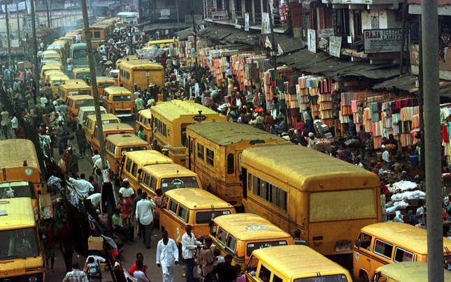 Pedestrians push their way through a traffic jam in downtown Lagos in 1999.