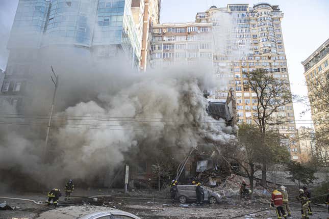 Firefighters conduct work in a destroyed building after Russian attacks in Kyiv, Ukraine on October 17, 2022