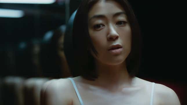 Hikaru Utada stands in front of a mirror in the video for the single "Pink Blood."