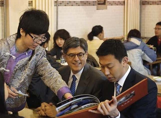 Lew (at center of photo) dining with the people in Beijing.