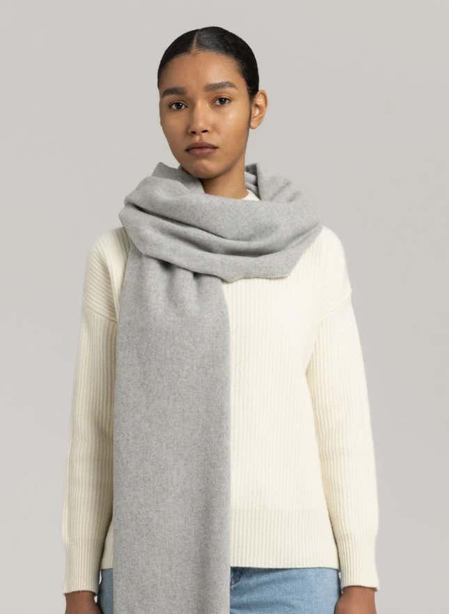 A model wears a gray Asket cashmere scarf