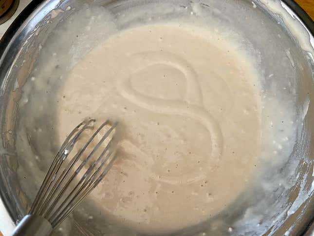 Pancake batter in a mixing bowl after whisking.