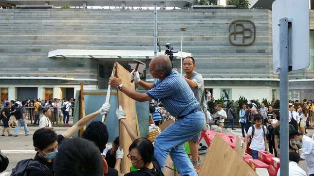 Rebuilding barricades on Queensway.