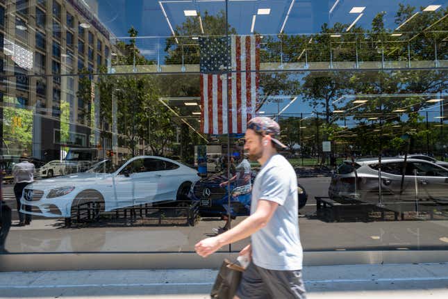 A person walks by a car dealership on June 10, 2022 in New York City. The Labor Department announced on Monday that consumer prices rose 8.6% last month from a year earlier. Inflation has risen to its highest level in four decades, raising the cost of airfare, hotels, vehicles, gas, and food. 
