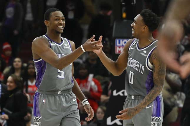 Mar 15, 2023; Chicago, Illinois, USA; Sacramento Kings guard De&#39;Aaron Fox (5) celebrates with guard Malik Monk (0) after Fox made a three-point basket to defeat the Chicago Bulls at the United Center.