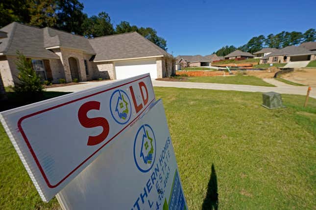 FILE - A "SOLD" sign decorates the lawn of a new house in Pearl, Miss., Sept. 23, 2021. U.S. home loan applications are at the lowest level in decades, the latest evidence that rising mortgage rates and home prices are shutting out many aspiring homeowners. (AP Photo/Rogelio V. Solis, File)