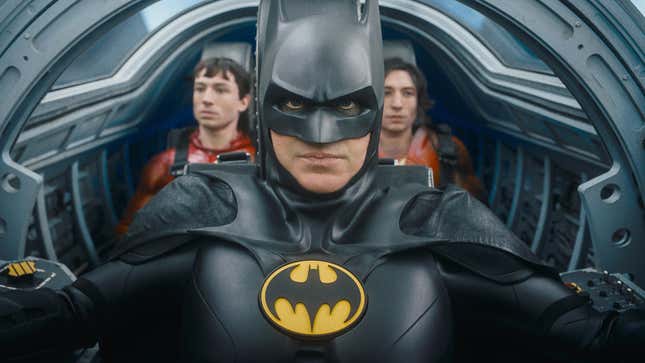 An image from The Flash showing Batman steering a vehicle with two versions of Barry Allen behind him