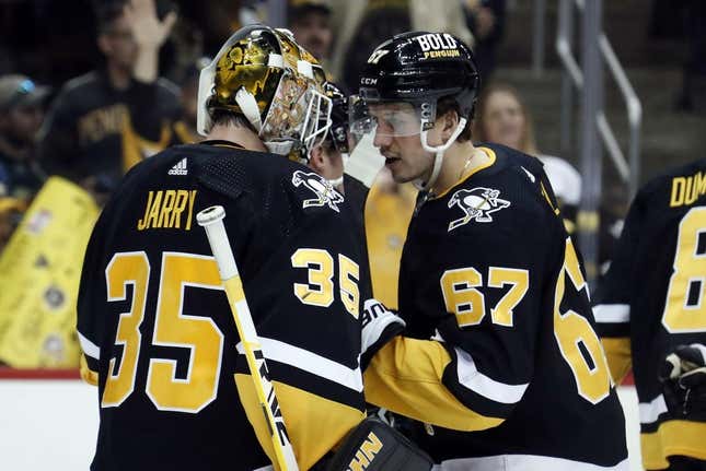 Apr 6, 2023; Pittsburgh, Pennsylvania, USA; Pittsburgh Penguins goaltender Tristan Jarry (35) and Pittsburgh Penguins right wing Rickard Rakell (67) celebrate after defeating the Minnesota Wild at PPG Paints Arena. Pittsburgh won 4-1.