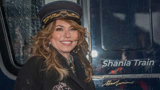 A photo of Shania Twain stood next to Shania Train. 