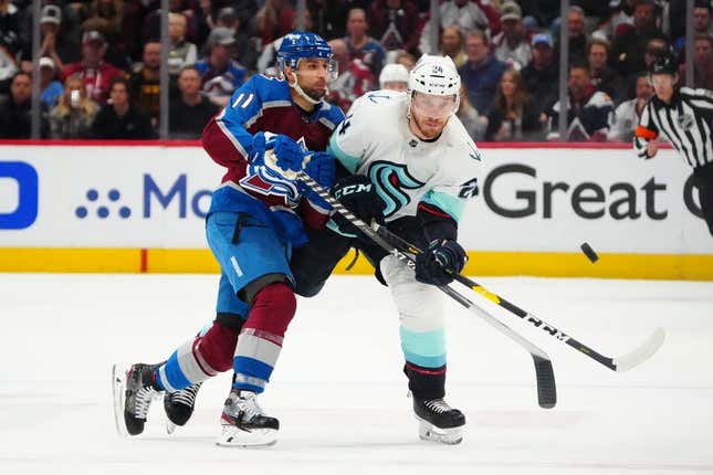 Apr 26, 2023; Denver, Colorado, USA; Colorado Avalanche center Andrew Cogliano (11) hits Seattle Kraken defenseman Jamie Oleksiak (24) in the first period in game five of the first round of the 2023 Stanley Cup Playoffs at Ball Arena.