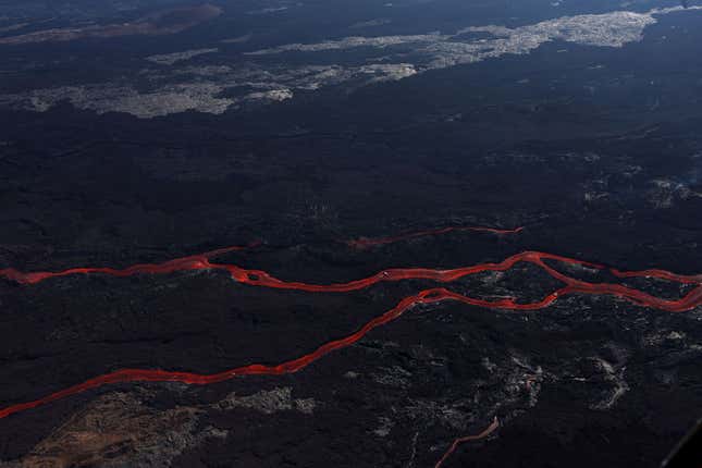 In an aerial view, lava flows from a fissure of Mauna Loa Volcano as it erupts on December 05, 2022 in Hilo, Hawaii.