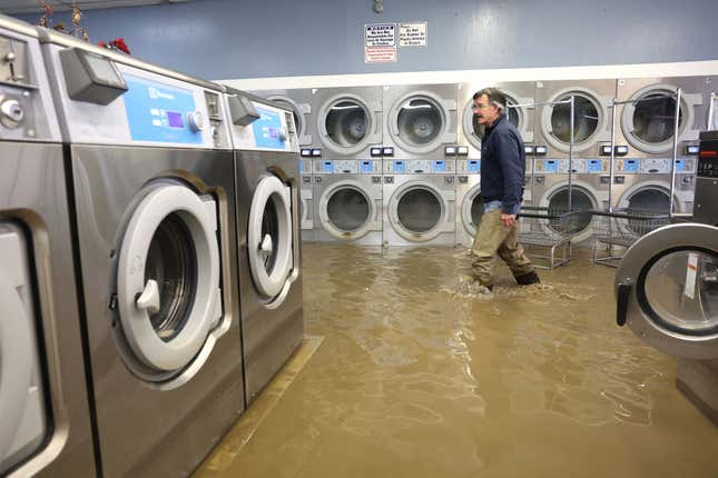 Patrick Cerruti walks through the flooded Pajaro Coin Laundry on March 14, 2023 in Pajaro, California. 