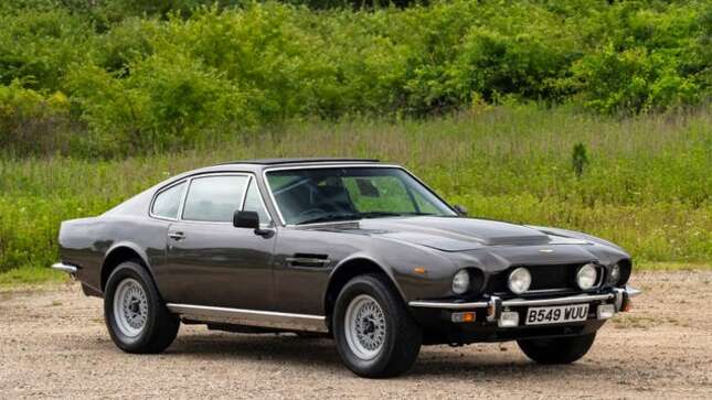 A photo of a grey Aston Martin V8 from the 1970s.