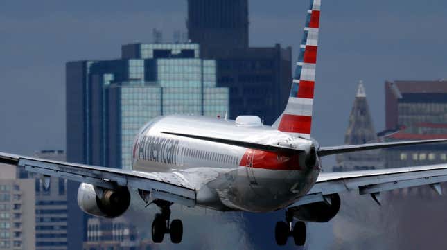 An American Airlines plane lands at Logan International Airport, Thursday, Jan. 26, 2023, in Boston.