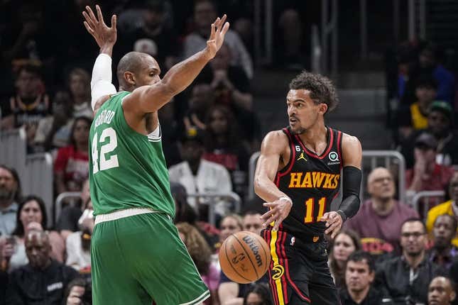 Apr 21, 2023; Atlanta, Georgia, USA; Atlanta Hawks guard Trae Young (11) passes behind Boston Celtics center Al Horford (42) during the first half during game three of the 2023 NBA playoffs at State Farm Arena.