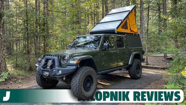 A photo of a green Jeep Gladiator fitted with a rooftop camper. 