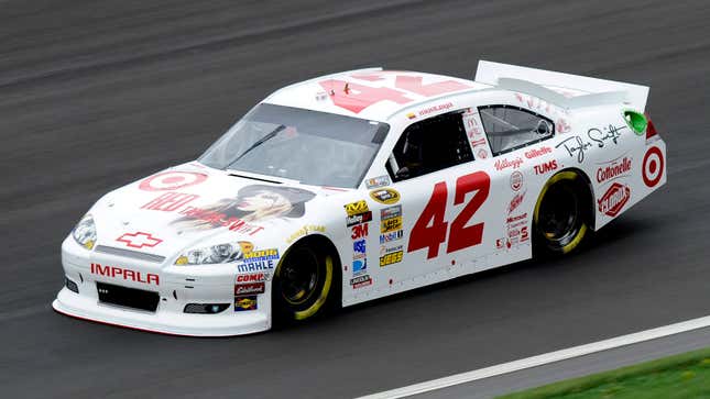 A photo of a white stock car with Taylor Swift branding on it. 