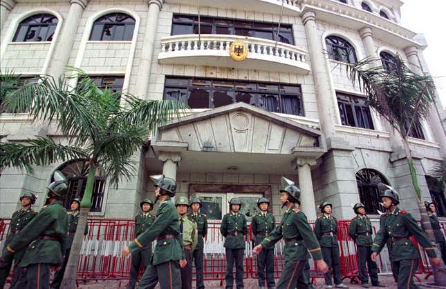 Chinese police stand guard on May 10, 1999 outside the German consulate in Guangzhou which was damaged in a protest against the NATO bombing on the Chinese embassy in Belgrade.