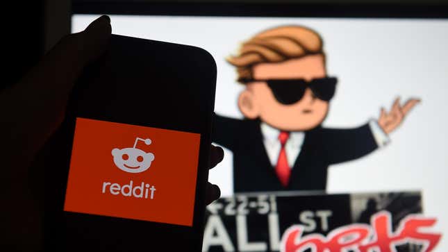 An image of a Reddit logo is shown on a phone in front of a cartoon drawing of the Wall Street Bets subreddit.